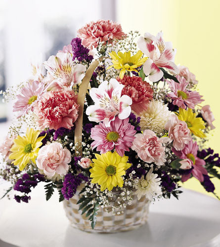 Pastel Basket of Cheer - Colourful flower arrangement in a basket.