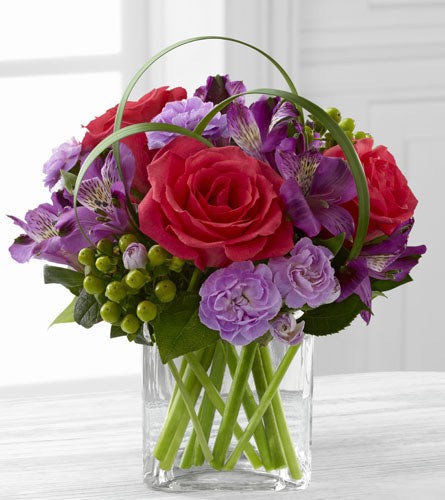 Be Bold Bouquet by Better Homes and Gardens - pink and purple flowers with green hypericum and lily grass in a cube.