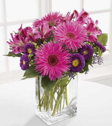 Garden Walk Bouquet - arrangement of pink and purple flowers in a clear vase.