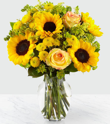 Daylight Bouquet in a Clear Vase - sunflowers, roses, spray roses and more in a clear glass vase.