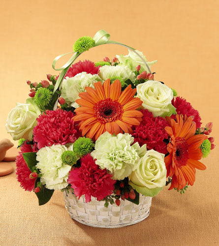 Best Year Basket - colourful flower arrangement in a white woven basket.