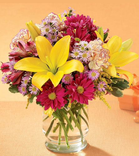 Happy Times Bouquet - arrangement of colourful flowers in a glass vase.