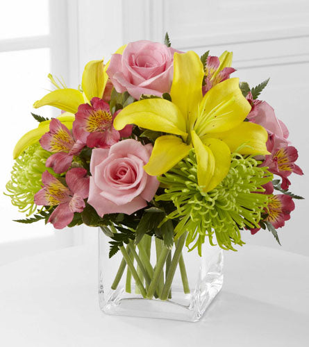 FTD's "Well Done" Arrangement -  Bouquet of pink roses, green Fuji chrysanthemums, pink Peruvian lilies, yellow Asiatic lilies in a clear vase. 