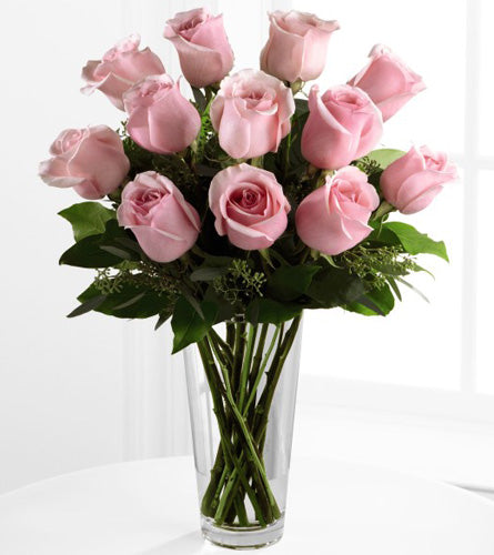 Pink Rose Bouquet - a dozen pink roses with greenery in a clear vase.