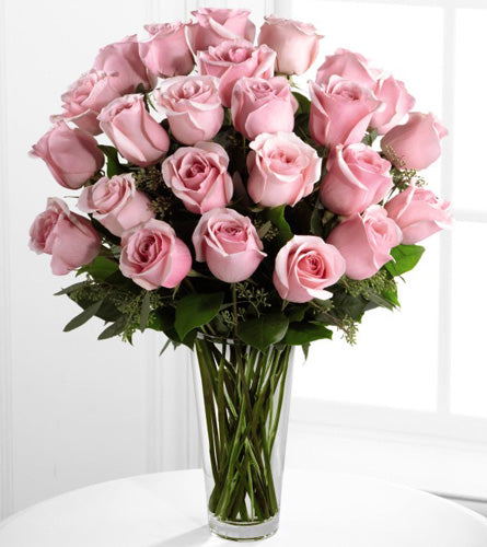 Premium Pink Rose Arrangement - bouquet of two dozen pink roses with greenery in a clear vase.