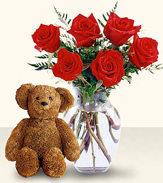 Six Red Roses in a Vase with Bear - brown teddy bear a clear glass vase of six red roses.
