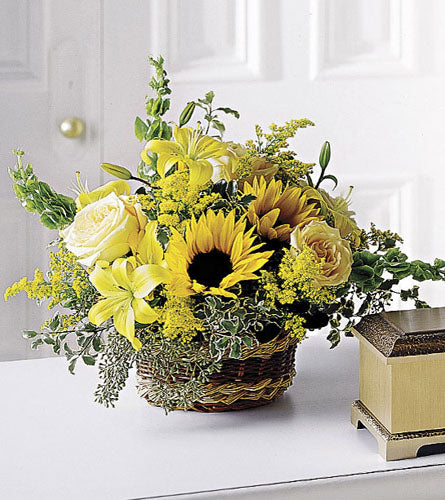 Flowing Garden Basket -  arrangement of yellow flowers in a woven basket.