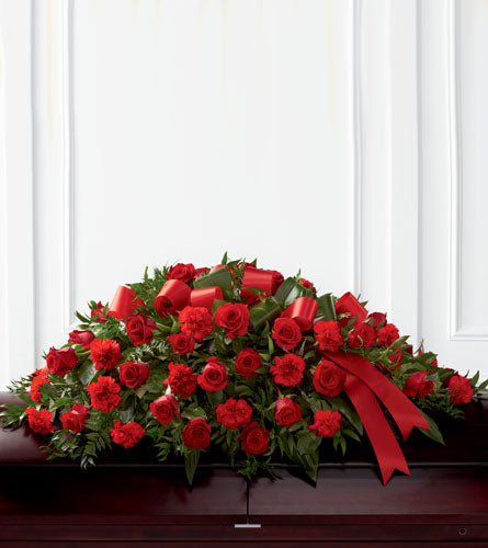 Dearly Departed Casket Spray - floral arrangement with red roses and ribbons.