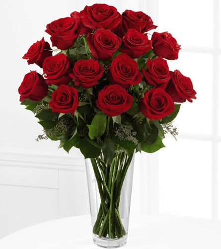 FTD's Deluxe Red Rose Arrangement - bouquet of eighteen red roses in a clear vase.