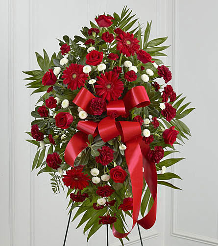 Treasured Memories Standing Spray - floral arrangement with red flowers and a large red bow.