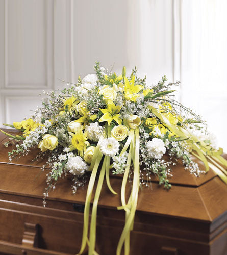 Rest in Peace Casket Spray - floral arrangement with yellow and white flowers and yellow ribbons.