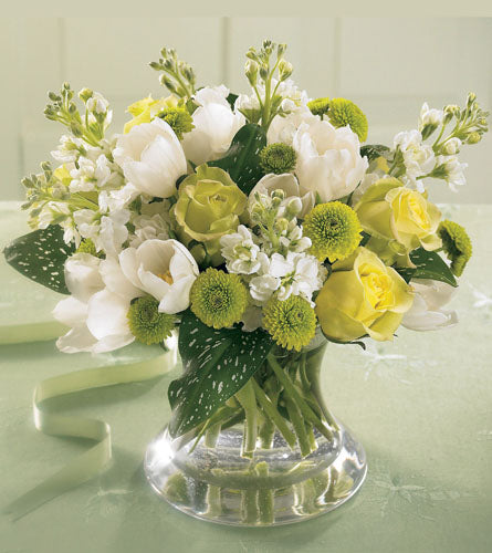 Faith & Understanding Bouquet - arrangement of white and yellow flowers in a clear vase.