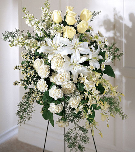 Quiet Tribute Standing Spray - floral arrangement with white and yellow flowers on a stand.