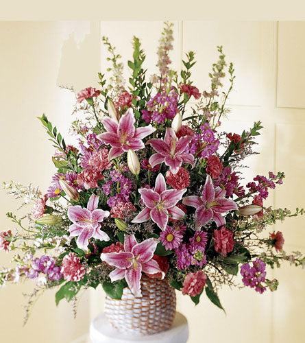 Leaf & Petals Basket - bouquet of pink lilies and other flowers in a woven basket.