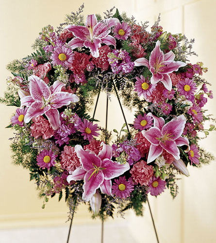 We Fondly Remember Wreath - floral wreath with pink lilies and other flowers on a stand