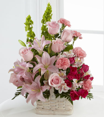 FTD's Beautiful Spirit Arrangement - colourful mix of pink, red and  white flowers in a white woven basket.
