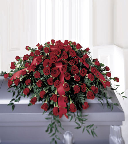 FTD'S Dearly Departed Casket Spray - Bouquet of red roses with a red ribbon 
