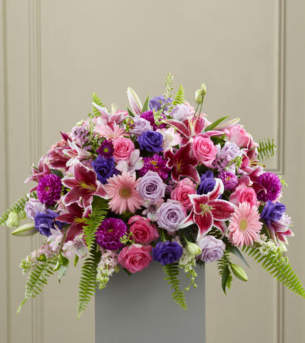 Fare Thee Well Pedestal Arrangement - colourful funeral design of mixed pink, purple, and blue flowers a top a pedestal.
