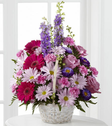 Pastel Peace Basket - Bouquet of colourful flowers in a white basket.