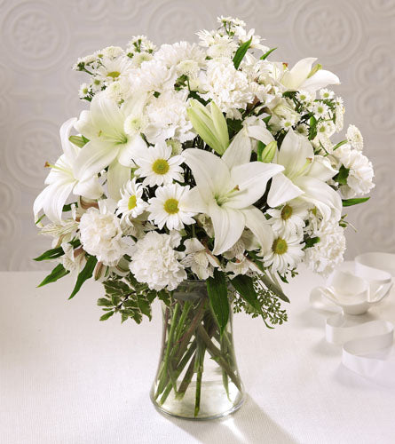 Angel Wings Arrangement - bouquet of white flowers in a clear glass vase.