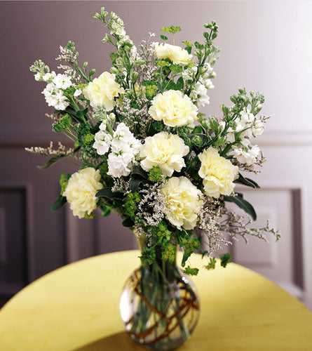 FTD's In Loving Memory Arrangement - bouquet of white and yellow flowers in a glass vase.