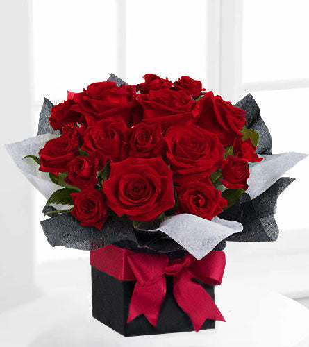 Teleflora's Fifth Avenue Present - Bouquet of red roses and spray roses in a black box with a red bow.