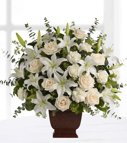 Teleflora's Loving Lilies and Roses Bouquet - arrangement of white lilies and roses with greenery in a brown vase.