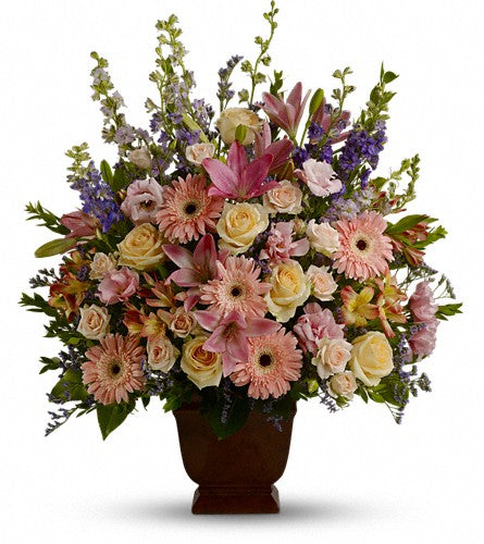 Teleflora's Loving Grace - bouquet of colourful flowers in a brown vase.