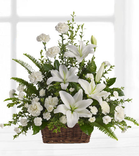 Peaceful White Lilies Basket - floral arrangement with white lilies and carnations with greenery in a dark brown basket.