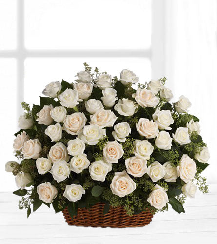 Bountiful Rose Basket - arrangement of white roses with greenery in a brown wicker basket.