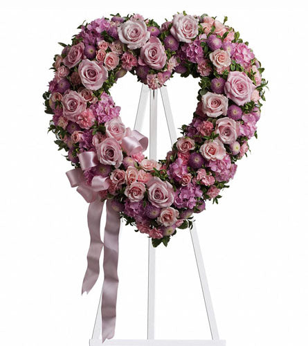Rose Garden Heart - Heart-shaped floral arrangement with pink and purple flowers on a white stand.