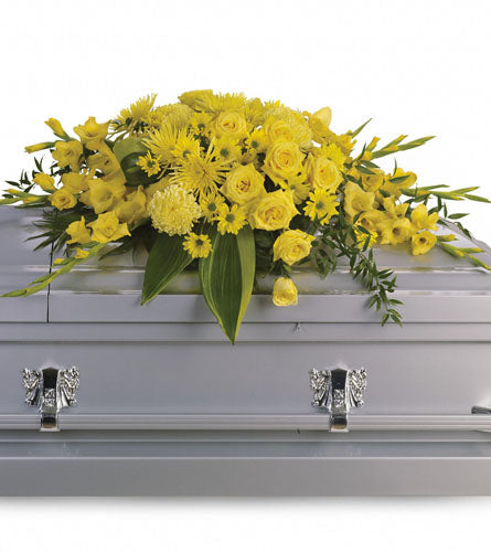 Graceful Grandeur Casket Spray - decorative arrangement of yellow carnations, roses and daisies with greenery. 