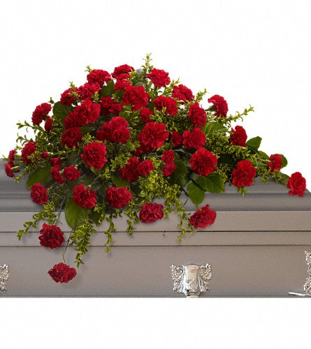 Adoration Casket Spray - red carnations and mini carnations with greenery.