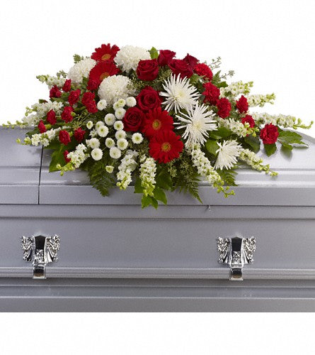 Strength and Wisdom Casket Spray - Floral arrangement with red and white flowers.