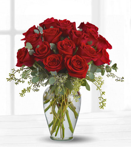 Full Heart - Bouquet of eighteen red roses with greenery in a clear vase.