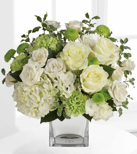 Teleflora's Shining On Bouquet - arrangement of white and green flowers in a clear cube vase.