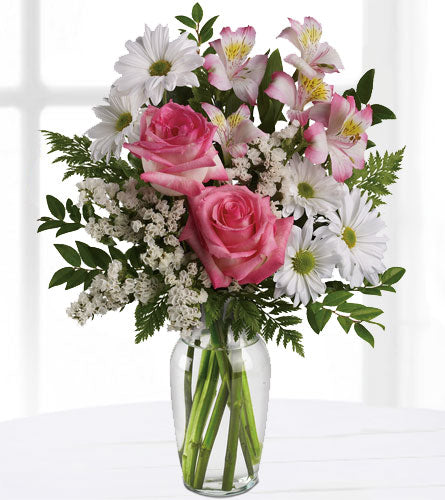What a Treat! - Bouquet of pink roses and white daisies in a clear vase.