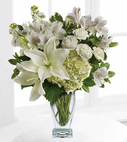 Purest Love Bouquet - arrangement of mixed white flowers in a clear glass vase.