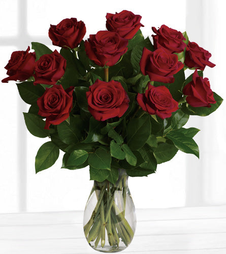 My True Love Bouquet - arrangement of a dozen red roses in a clear glass vase.