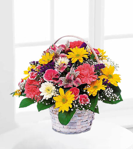 Simple Pleasures Basket - Colourful flower arrangement in a white washed basket.