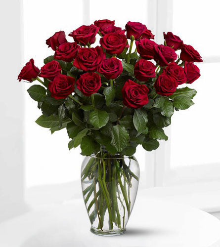 Two Dozen Red Roses - Bouquet of twenty four red roses with greenery in a clear vase.