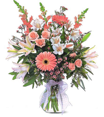 Celebrating Baby Girl Arrangement - bouquet of flowers with coral gerbera daisies, pink roses, and white lilies in a clear vase with a white bow.