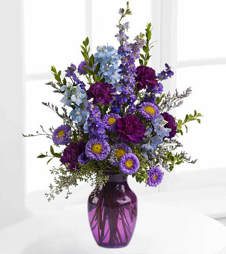 Purple Majesty - purple, blue and lavender floral arrangement in a large purple glass vase.