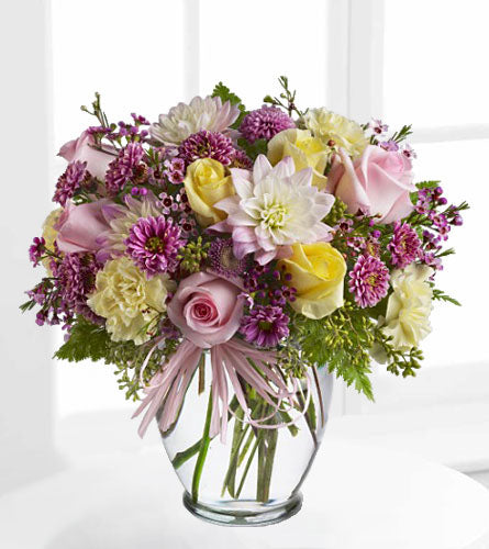 Soft and Beautiful - floral arrangement of mixed colourful flowers in a clear glass vase.