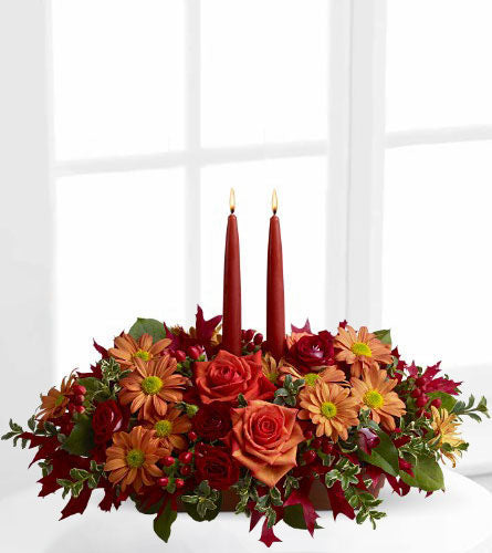 Autumn Lights - decorative floral arrangement of fall flowers with red candles.