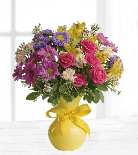 Colour It Happy - Bouquet of colourful mixed flowers in a yellow vase with a yellow bow.