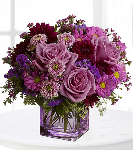 Rosy Day - Bouquet of lavender and purple flowers in a lavender cube vase.