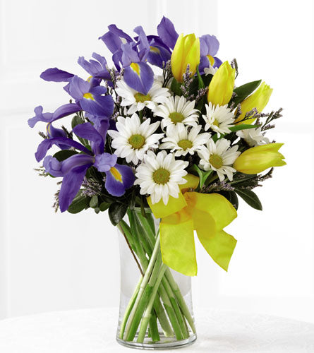 Sunshine Style by Better Homes & Gardens - bouquet of blue iris, yellow tulips, and white daisies in a clear vase.