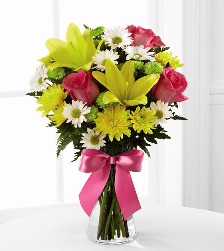 The Sweetest Blooms - Bouquet with yellow lilies, pink roses, and white daisies in a clear vase.